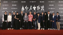 The team of movie "Detention" pose on the red carpet at the 2020 Taipei Film Festival in Taipei, Taiwan, Saturday, July 11, 2020. The 2020 Taipei Film Festival is the world's first large-scale film festival held by an entity after the outbreak of the COVID-19 epidemic. (AP Photo/Chiang Ying-ying)