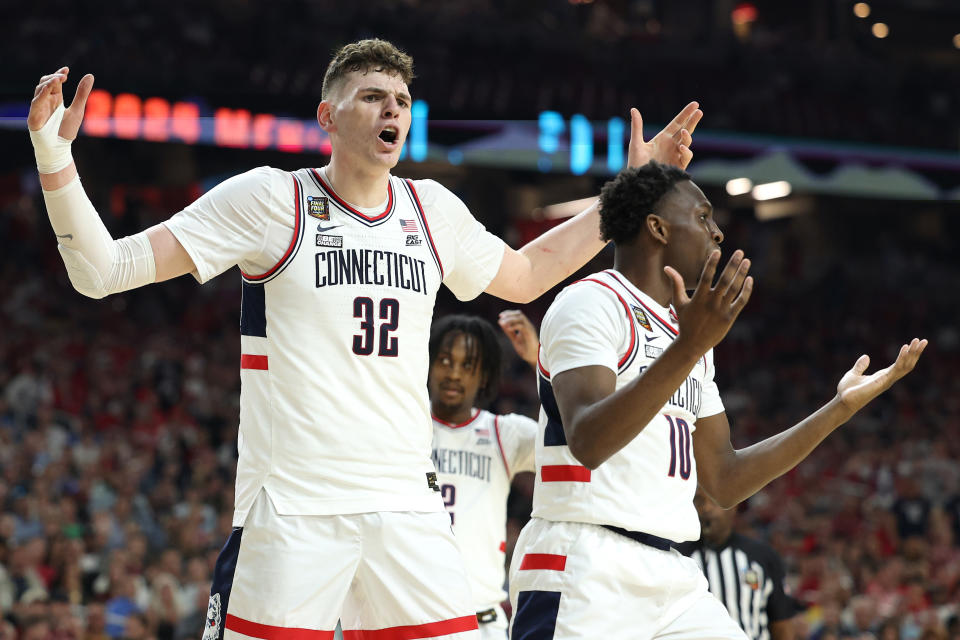 GLENDALE, ARIZONA - APRIL 06: Donovan Clingan #32 and Hassan Diarra #10 of the Connecticut Huskies react in the second half against the Alabama Crimson Tide in the NCAA Men's Basketball Tournament Final Four semifinal game at State Farm Stadium on April 06, 2024 in Glendale, Arizona. (Photo by Jamie Squire/Getty Images)