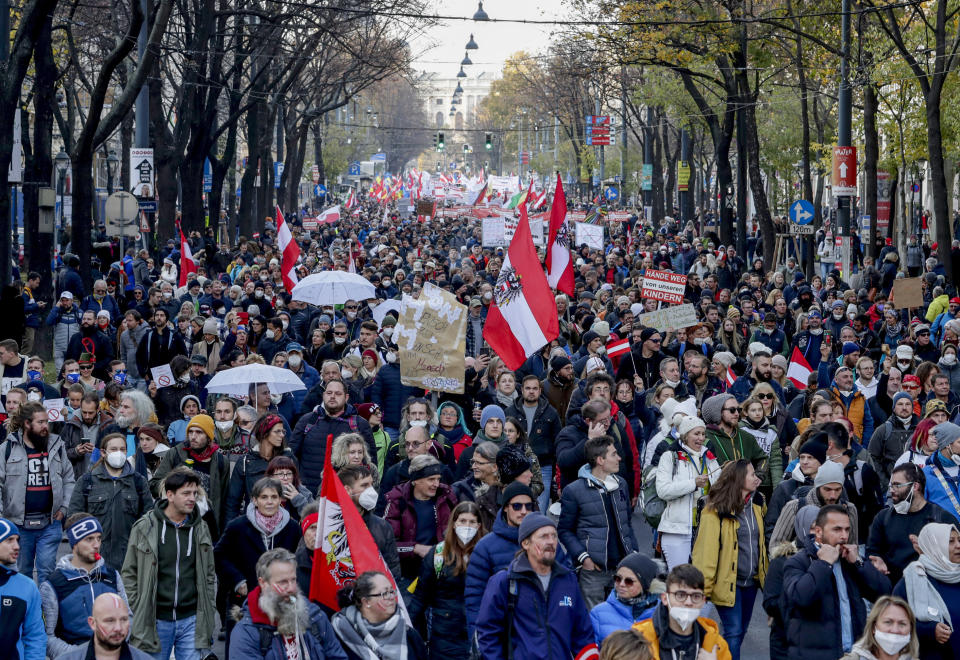 Hundreds of people take part in a demonstration against the country's coronavirus restrictions in Vienna, Austria, Saturday, Nov.20, 2021. Thousands of protesters are expected to gather in Vienna after the Austrian government announced a nationwide lockdown to contain the quickly rising coronavirus infections in the country. (AP Photo/Lisa Leutner)