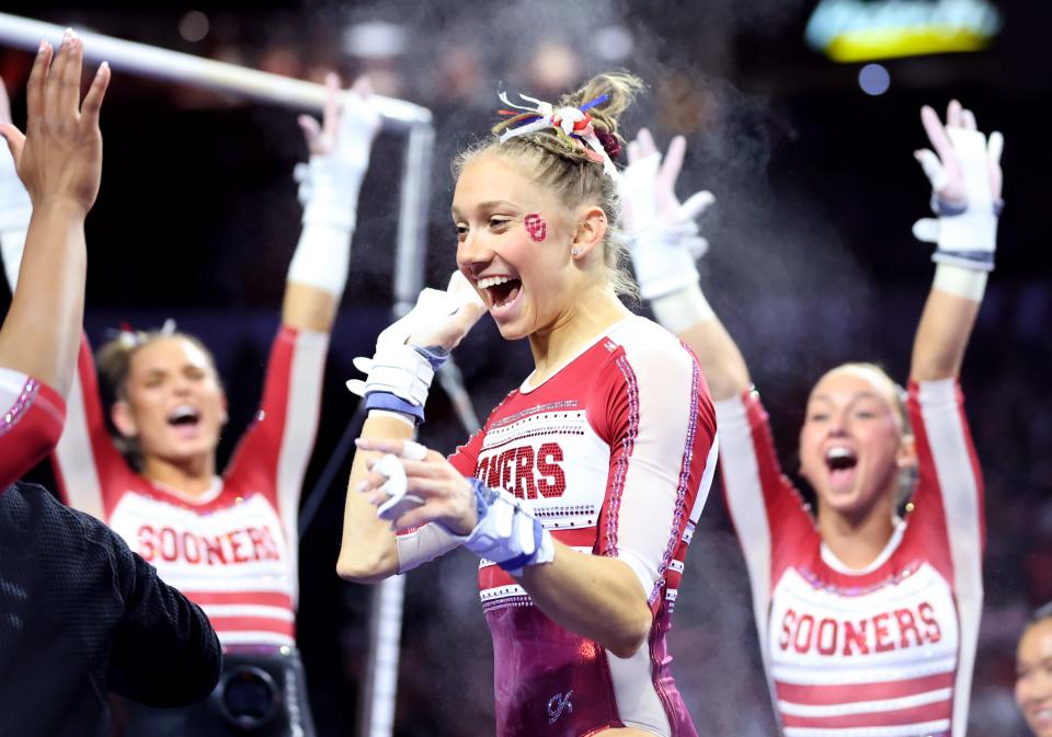 OU's Katherine LeVasseur celebrates after the bars during Friday's gymnastics meet against BYU, Texas Woman's University and Utah State at Lloyd Noble Center in in Norman.