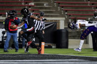 Cincinnati wide receiver Tre Tucker, left, makes a catch for a touchdown in front of East Carolina defensive back Juan Powell, right, during the first half of an NCAA college football game Friday, Nov. 13, 2020, in Cincinnati. (AP Photo/Aaron Doster)