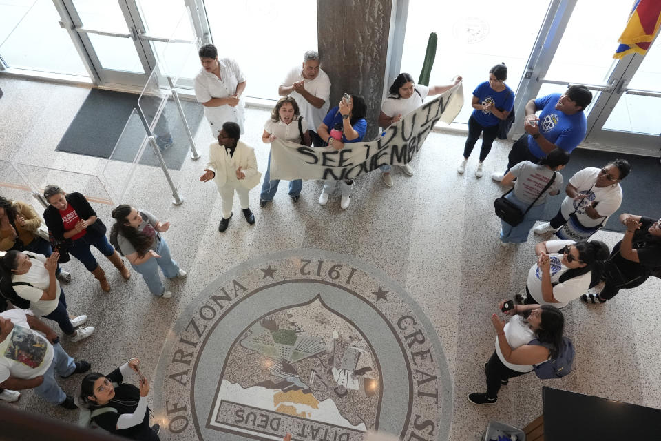 Opponents gather inside the Arizona State Capitol, Tuesday, June 4, 2024, in Phoenix after the Arizona legislature gave final approval to a the proposal that will ask voters to make it a state crime for noncitizens to enter the state through Mexico at any location other than a port of entry. (AP Photo/Matt York)
