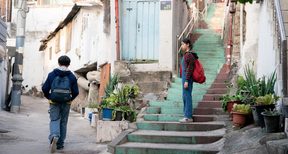 Young Hae Sung (Leem Seung-min) and young Nora (Moon Seung-ah) part ways on the walk home from school in Seoul.<span class="copyright">Courtesy of A24</span>