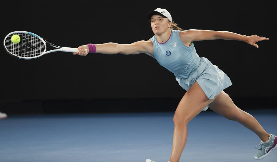 Poland's Iga Swiatek hits a forehand return during her fourth round match against Romania's Simona Halep at the Australian Open tennis championship in Melbourne, Australia, Sunday, Feb. 14, 2021.(AP Photo/Hamish Blair)