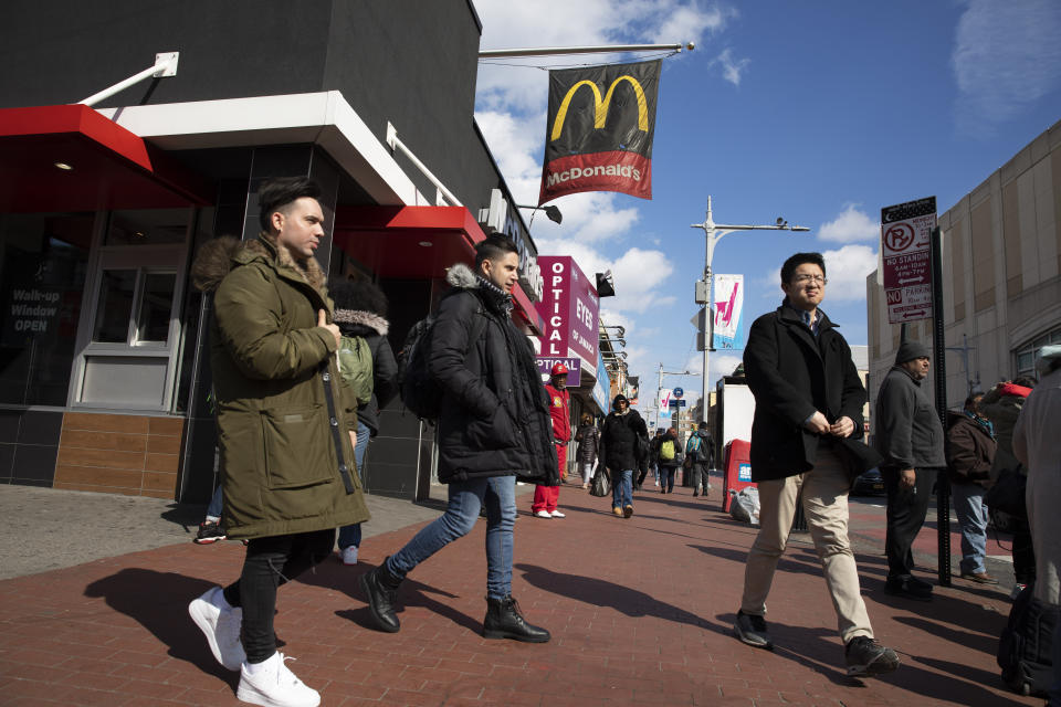 In this Feb. 28, 2020 photo, Venezuelan Kamal Morales, center, walks through his New York neighborhood. Morales' Venezuelan boyfriend, Gustavo Acosta, has spent the past year moving around U.S. immigrant detention centers in the deep south after they crossed the Mexico-U.S. border together to apply for asylum. Morales’ own asylum request was rejected and he was ordered deported, but is currently living in New York while on parole. (AP Photo/Mark Lennihan)