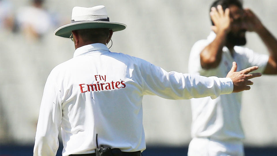 An umpire signals for a no-ball.