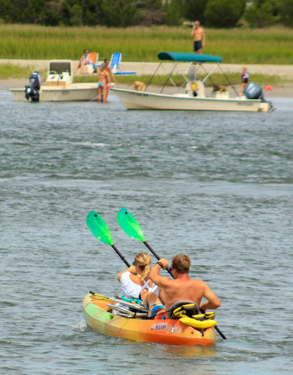 Kayakers paddle along Banks Channel at Wrightsville Beach, N.C. Saturday August 31, 2019, over Labor Day weekend as they enjoy the last official beach weekend of the season.