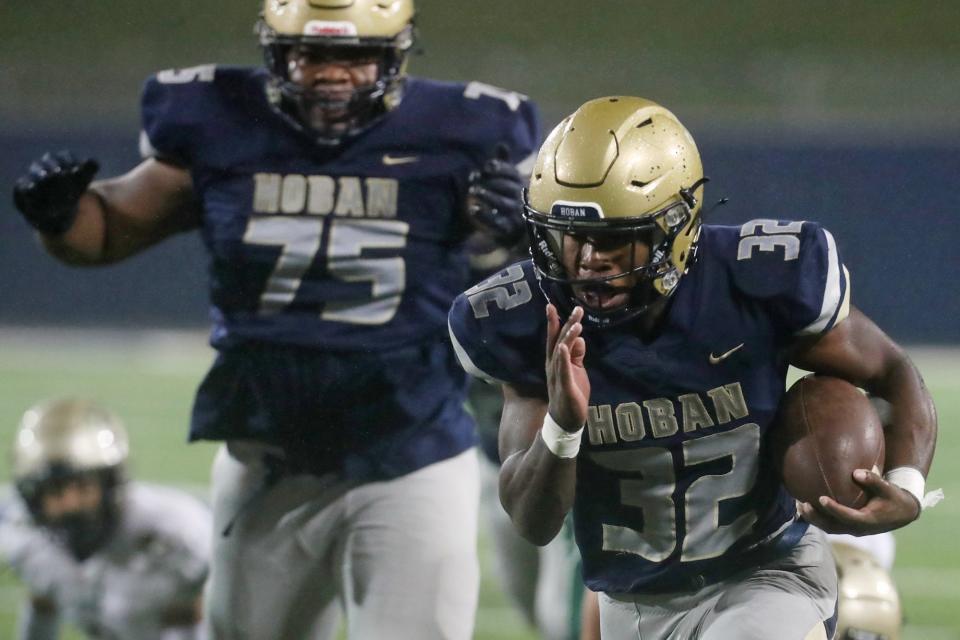 Hoban's Lamar Sperling heads for his third touchdown as Zardakar Zaramo cheers him on against St. Vincent-St Mary in the second quarter of a Division II regional semifinal at the University of Akron on Friday, Nov. 11, 2022.