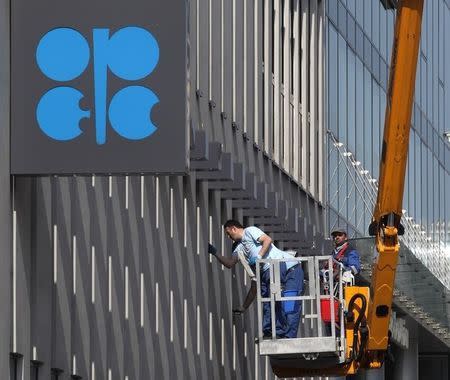 Workers clean the windows of the Organization of the Petroleum Exporting Countries (OPEC) headquarters in Vienna April 7, 2014. REUTERS/Heinz-Peter Bader