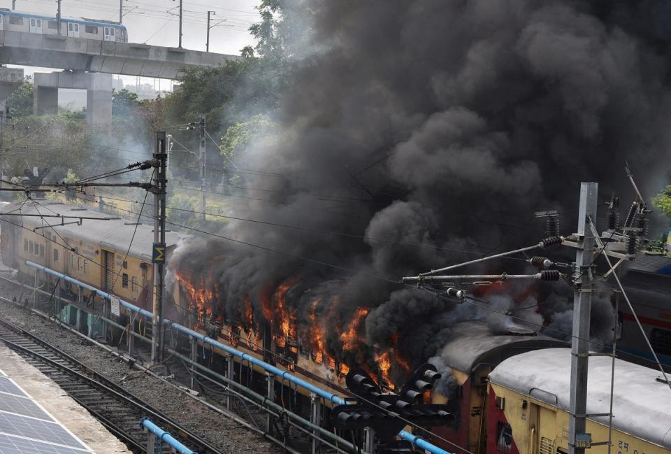 Protesters set fire to a train in protest in the southern state of Telangana (Reuters)