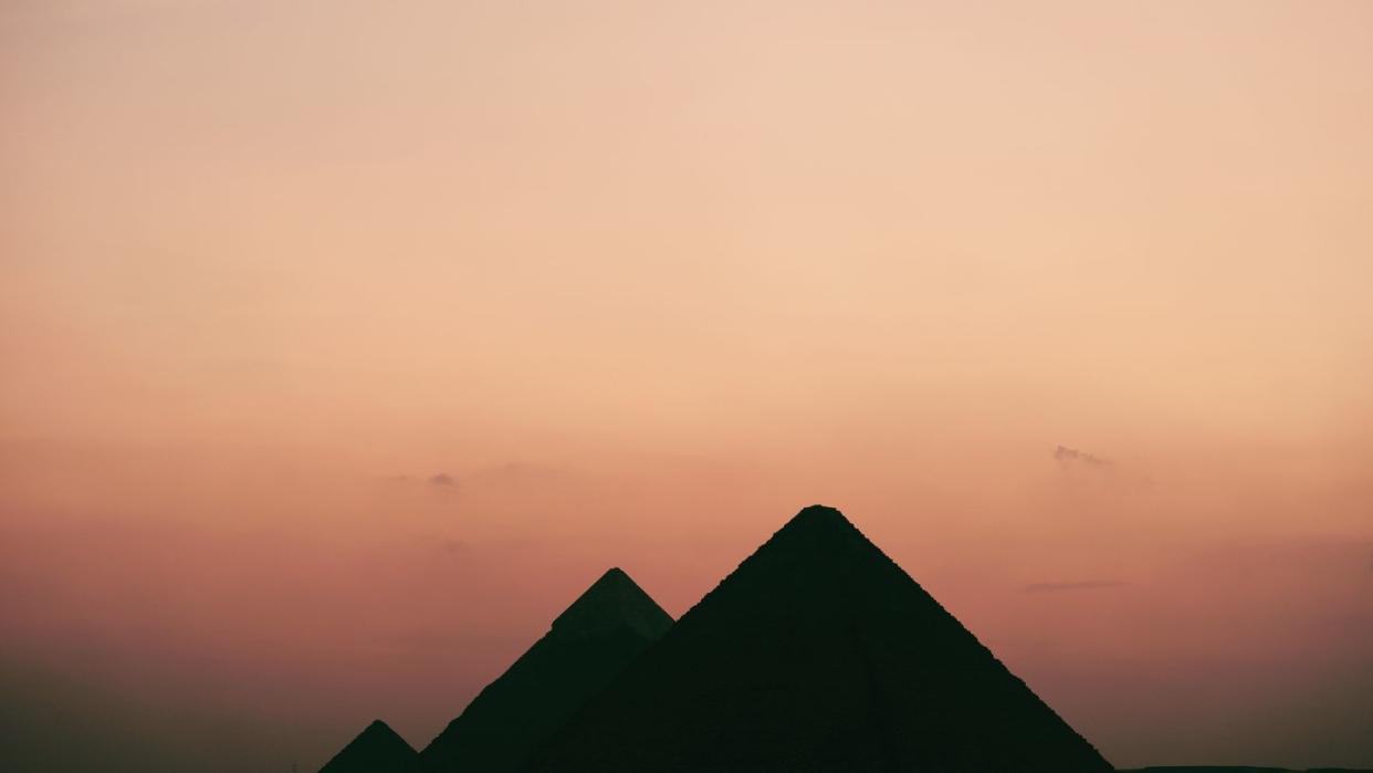 silhouette of built structure against sky during sunset