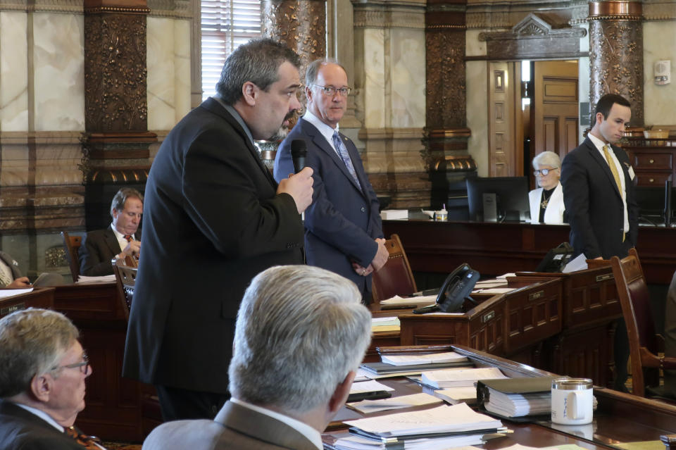 Kansas state Sen. Richard Hilderbrand, left, R-Galena, makes a point during a debate on a bill that would legalize sports betting as Senate Vice President Jeff Longbine, R-Emporia, watches, Wednesday, Feb. 26, 2020, at the Statehouse in Topeka, Kan. The measure would allow four state-owned casinos to offer sports betting as a part of the Kansas Lottery. (AP Photo/John Hanna)