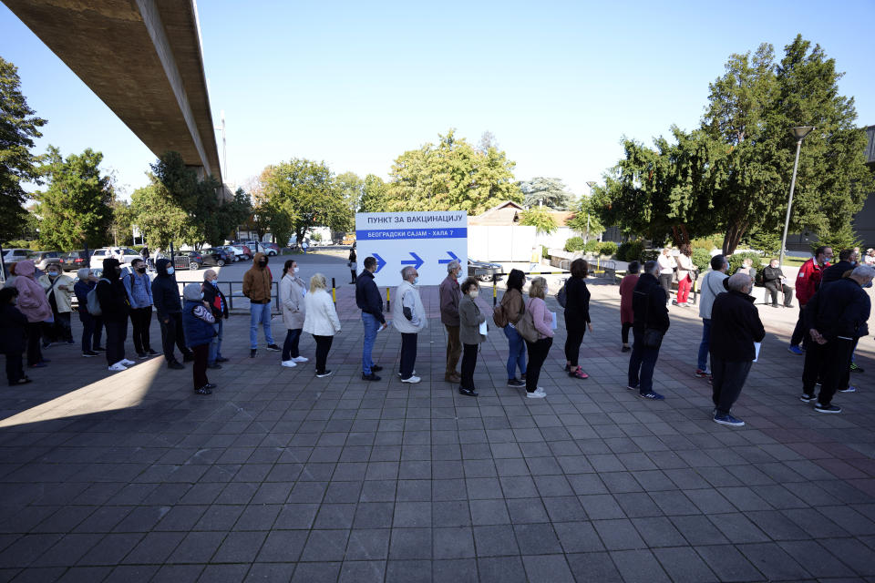 People wait in line to receive a dose of a COVID-19 vaccine at Belgrade Fair makeshift vaccination center in Belgrade, Serbia, Saturday, Oct. 2, 2021. Russians are flocking to Serbia to receive Western-approved COVID-19 shots. Although Russia has its own vaccine known as Sputnik V, the shot has not been approved by international health authorities. (AP Photo/Darko Vojinovic)