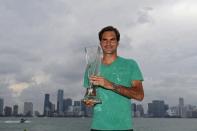 Apr 2, 2017; Key Biscayne, FL, USA; Roger Federer of Switzerland poses for a champion's portrait with the Butch Buchholz Trophy in front of the Miami skyline after his match against Rafael Nadal of Spain (not pictured) in the men's singles championship of the 2017 Miami Open at Crandon Park Tennis Center. Federer won 6-3, 6-4. Mandatory Credit: Geoff Burke-USA TODAY Sports