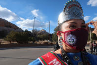 Miss Navajo Shaandiin Parrish awaits the arrival of First Lady Jill Biden at a Navajo Nation tribal park in Window Rock, Ariz., on Thursday, April 22, 2021. The trip is Biden’s third to the vast reservation that stretches into Arizona, New Mexico and Utah. (AP Photo/Felicia Fonseca)