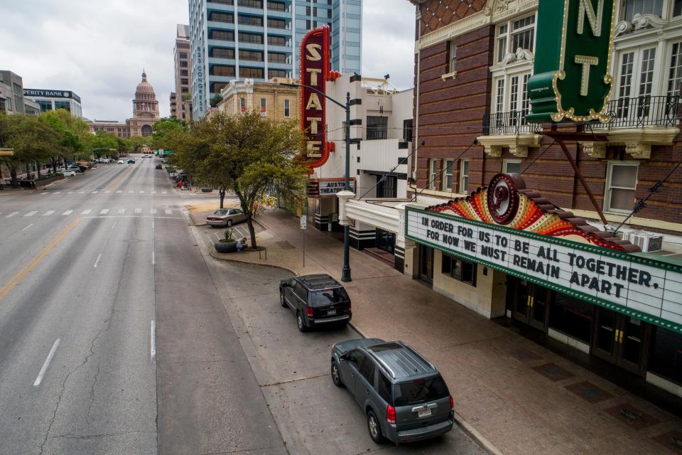 Congress Avenue in Austin, Texas, is devoid of its usual heavy traffic in this photo taken around 11:30 a.m. on March 17, 2020, amid the coronavirus outbreak. A hopeful message is on the marquee at the Paramount Theatre.