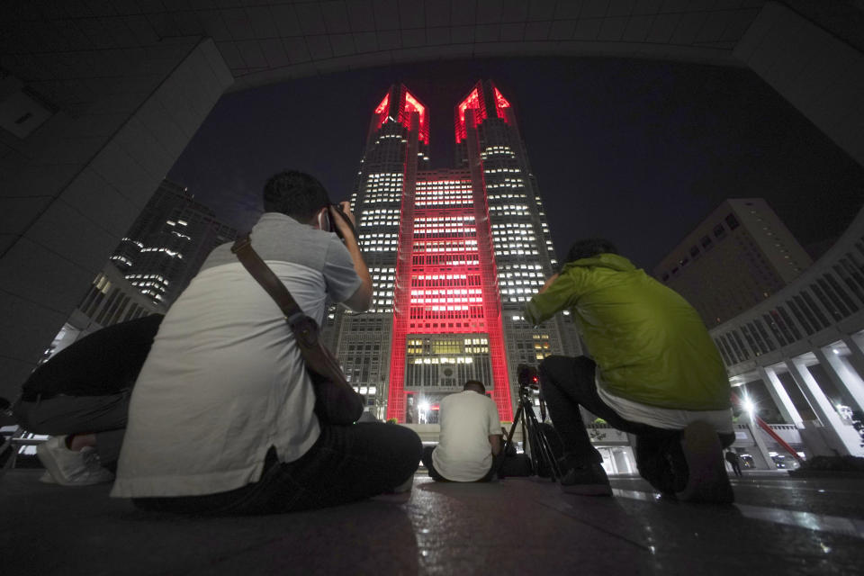 The Tokyo Metropolitan Government Building, one of city's landmarks, is illuminated in red as warning for metropolitan citizens as the number of new corona virus infections become higher, Tuesday, June 2, 2020, in Tokyo. Tokyo issued a coronavirus alert Tuesday for the Japanese capital amid fear of a resurgence of the infections only a week after a state of emergency was lifted. Governor Yuriko Koike issued a "Tokyo alert" after seeing 34 new cases Tuesday in the city, where the infections had slowed to a few per day in late May. (AP Photo/Eugene Hoshiko)