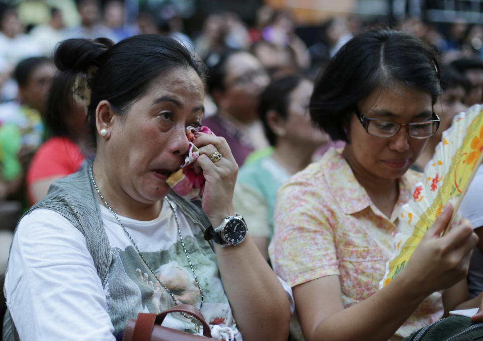 A Filipino devotee wipes tears as she watches the live satellite broadcast of the canonization or the elevation to sainthood in the Vatican of Roman Catholic Pope John Paul II and Pope John XXIII on Sunday, April 27, 2014 in suburban Quezon city, north of Manila, Philippines. Pope Francis declared his two predecessors John XXIII and John Paul II saints on Sunday before hundreds of thousands of people in St. Peter's Square, an unprecedented ceremony made even more historic by the presence of retired Pope Benedict XVI. The predominantly Roman Catholic Philippines joins several nations worldwide in the celebration of canonization of the two Popes. (AP Photo/Aaron Favila)