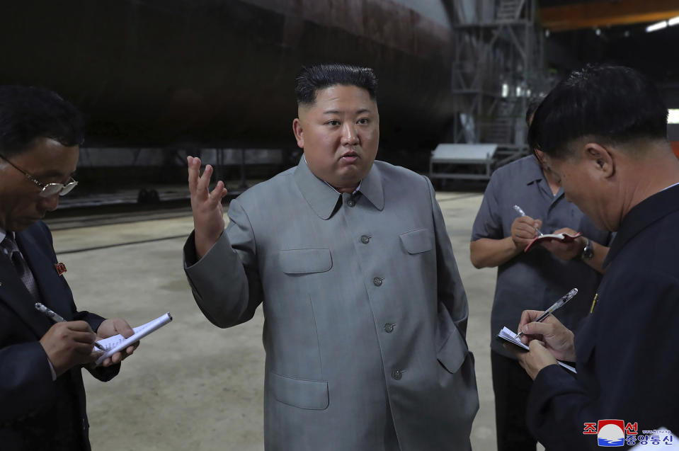 In this undated photo provided on Tuesday, July 23, 2019, by the North Korean government, North Korean leader Kim Jong Un, center, speaks while inspecting a newly built submarine to be deployed soon, at an unknown location in North Korea. North Korean state media's report on Tuesday comes days after North Korea said it may lift its 20-month suspension of nuclear and missile tests to protest expected military drills between the United States and South Korea. Independent journalists were not given access to cover the event depicted in this image distributed by the North Korean government. The content of this image is as provided and cannot be independently verified. Korean language watermark on image as provided by source reads: "KCNA" which is the abbreviation for Korean Central News Agency. (Korean Central News Agency/Korea News Service via AP)