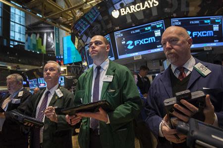 Traders stand on the floor of the New York Stock Exchange February 18, 2014. REUTERS/Brendan McDermid