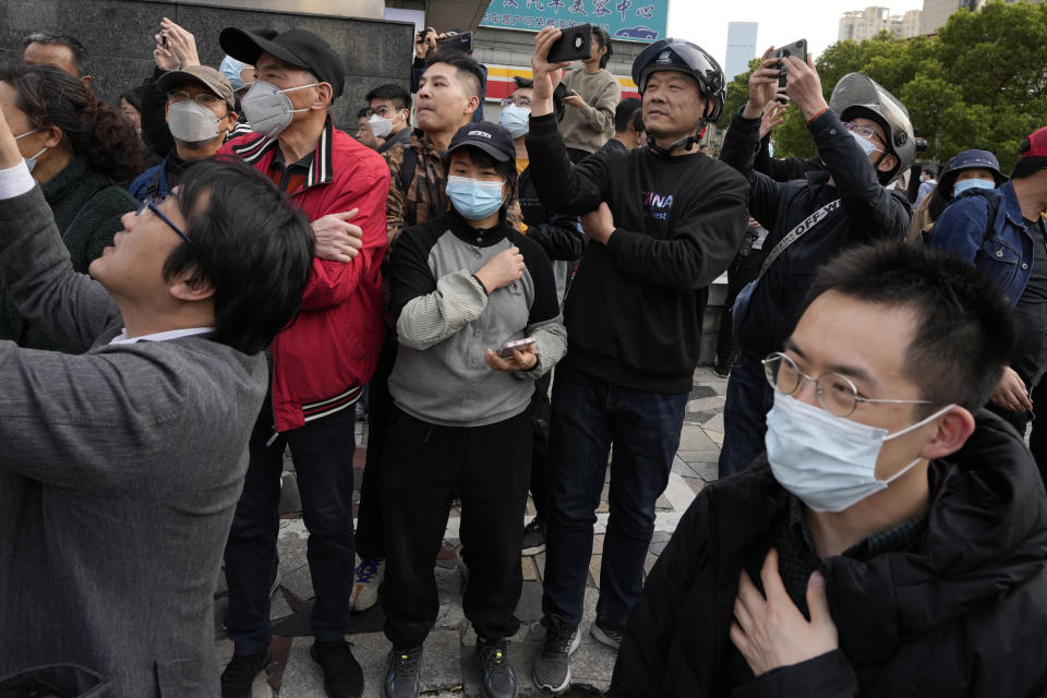 Residents try to catch a glimpse of former Taiwan President Ma Ying-jeou during his visit in Nanjing, in eastern China's Jiangsu province, Tuesday, March 28, 2023. Former Taiwan President Ma Ying-jeou began a 12-day tour of China with a symbolism-laden visit to the mausoleum where the founding father of both China and Taiwan is entombed. (AP Photo/Ng Han Guan)