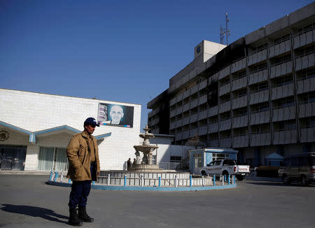 An Afghan security guard stands in front of the Intercontinental Hotel after an attack in Kabul, Afghanistan January 23, 2018.REUTERS/Mohammad Ismail