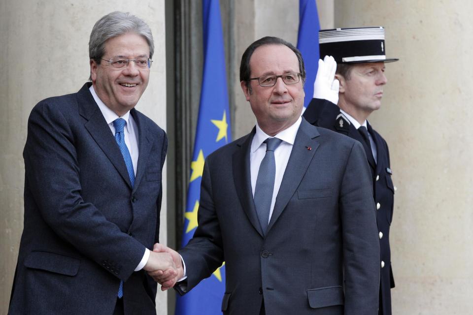 FILE - In this Jan. 10, 2016 file photo, French President Francois Hollande, right, welcomes Italian Premier Paolo Gentiloni before their talks at the Elysee Palace in Paris. According to reports Wednesday, Jan. 11, 2016, Gentiloni was hospitalized in Rome upon his return from Paris following a sudden indisposition and successfully underwent a minor angioplasty surgery. (AP Photo/Christophe Ena, FILE)