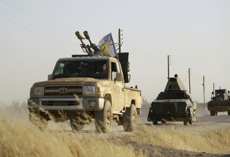 US-backed Kurdish and Arab fighters advance into the Islamic State jihadist group's bastion of Manbij in northern Syria, on June 23, 2016