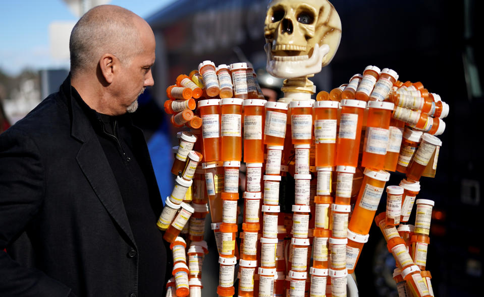 Frank Huntley looks at his sculpture made out of the opioid pill bottles he got when addicted, set up outside Democratic presidential candidate and former Vice President Joe Biden's campaign event in Somersworth, New Hampshire, U.S., February 5, 2020. REUTERS/Rick Wilking