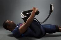 Paralympic sprinter Jerome Singleton stretches while posing for a portrait during the 2012 U.S. Olympic Team Media Summit in Dallas, May 15, 2012.