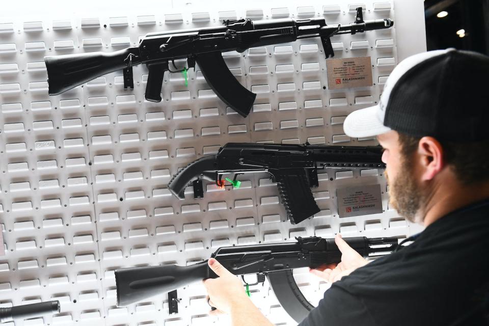 An attendee holds AK-47 style semi-automatic rifles during the National Rifle Association annual meeting in Houston on May 28, 2022. <a href="https://media.gettyimages.com/photos/attendees-hold-american-made-ak47-style-762mm-semiautomatic-rifles-picture-id1240972852?s=2048x2048" rel="nofollow noopener" target="_blank" data-ylk="slk:Patrick T. Fallon/AFP via Getty Images;elm:context_link;itc:0;sec:content-canvas" class="link ">Patrick T. Fallon/AFP via Getty Images</a>