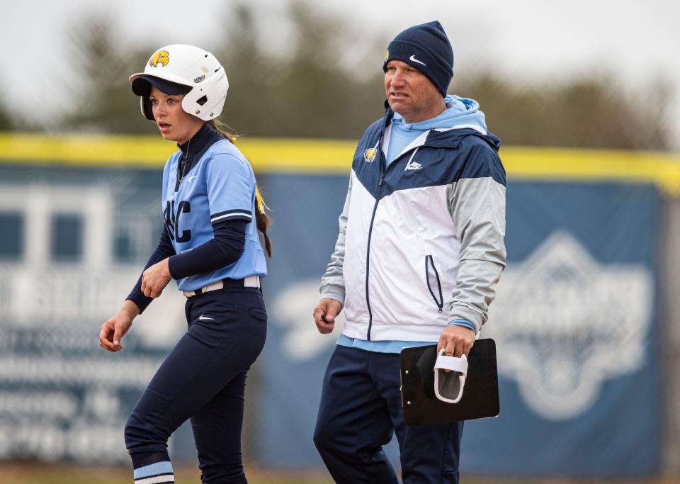 Rock Valley's assistant coach D.J Johnson speaks to Kelli Riordan at first base against Lake County on Friday, April 15, 2022, at Rock Valley College in Rockford.