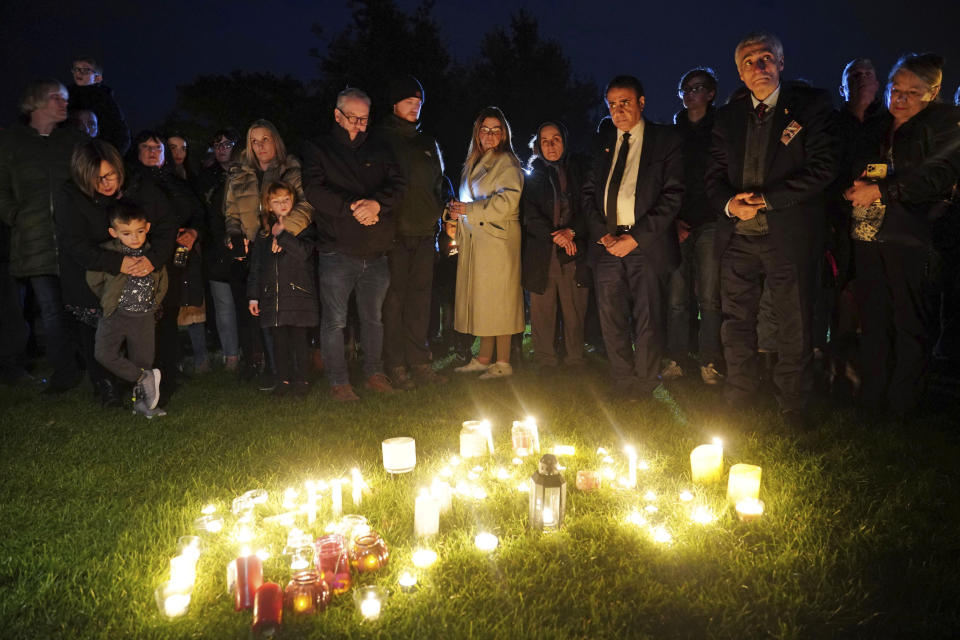 People gather during a candlelight vigil at Belfairs Recreation Ground near to Belfairs Methodist Church where Conservative MP Sir David Amess died after he was stabbed several times at a constituency surgery on Friday, in Leigh-on-Sea, Essex, England, Saturday, Oct. 16, 2021. The fatal stabbing of a British lawmaker has cast fresh doubt on the continued viability of what he had called “the great British tradition” of parliamentarians readily meeting voters. The regular and roving “surgeries” that British legislators hold for their constituents set them apart from lawmakers in other countries where the governed rarely — if ever — get to meet those who govern them. (Dominic Lipinski/PA via AP)