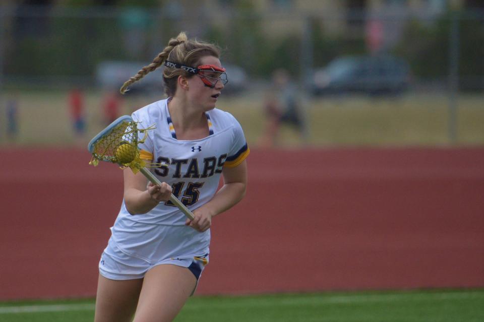 Poudre School District girls lacrosse player Laney Nesbitt looks for a teammate during a game against Conifer on April 22.