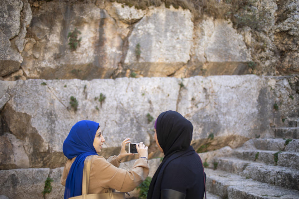 In this Thursday, Oct. 31, 2019 photo, Muslim women visits the Tomb of the Kings, a large underground burial complex dating to the first century BC, in east Jerusalem neighborhood of Sheikh Jarrah. After several aborted attempts, the French Consulate General has reopened one of Jerusalem's most magnificent ancient tombs to the public for the first time in over a decade, sparking a distinctly Jerusalem conflict over access to an archaeological-cum-holy site in the volatile city's eastern half. (AP Photo/Ariel Schalit)