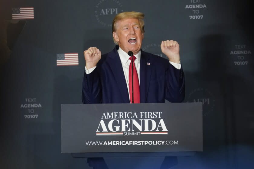 Former President Donald Trump talks about lifting weights as he speaks at an America First Policy Institute agenda summit at the Marriott Marquis in Washington, Tuesday, July 26, 2022. (AP Photo/Andrew Harnik)