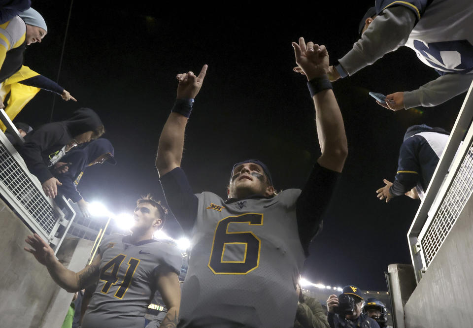 West Virginia quarterback Garrett Greene (6) celebrates after a win over Baylor as he heads to the locker room after an NCAA college football game, Saturday, Nov. 25, 2023, in Waco, Texas. (Jerry Larson/Waco Tribune-Herald, via AP)