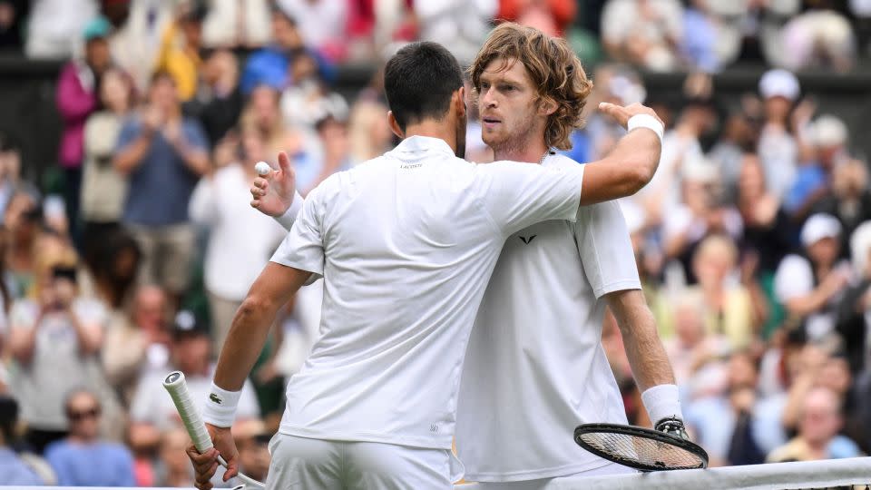 Novak Djokovic and Andrey Rublev embrace after their thrilling clash. - Daniel Leal/AFP/Getty Images