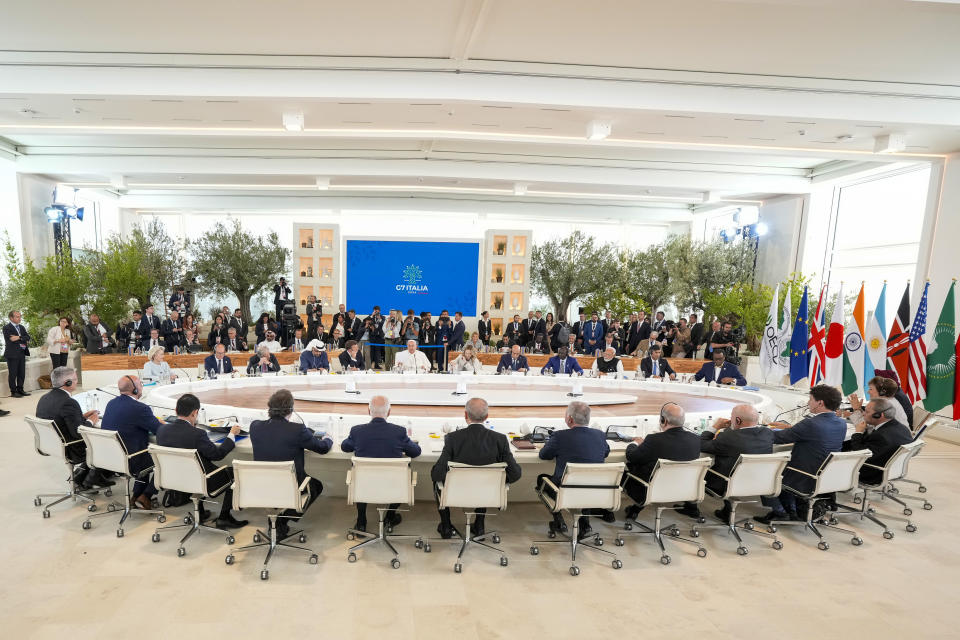 Pope Francis, center, addresses world leaders during a working session on AI, Energy, Africa and Mideast at the G7 summit, in Borgo Egnazia, near Bari in southern Italy, Friday, June 14, 2024. (AP Photo/Andrew Medichini)