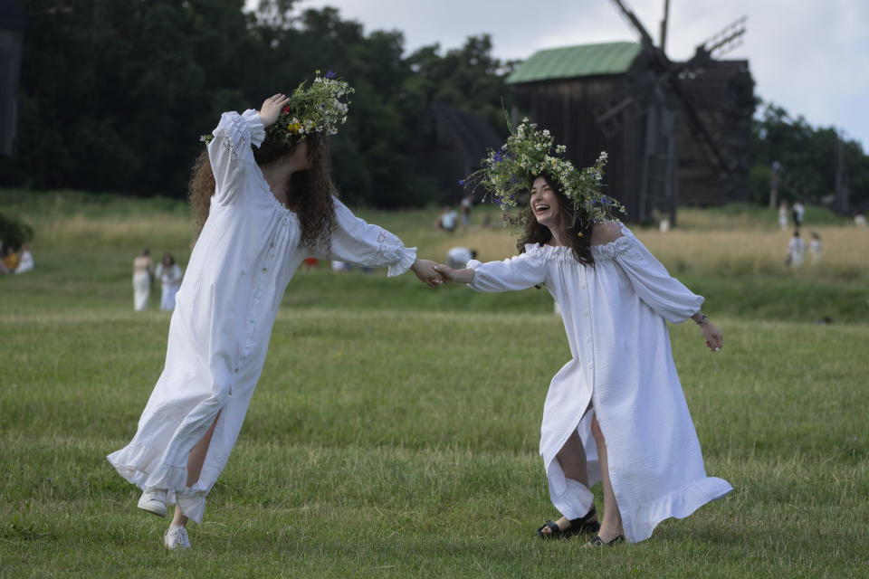 Ukrainian young women dressed in traditional clothing dance at a traditional Midsummer Night celebration near capital Kyiv, Ukraine, Sunday, June 23, 2024. The age-old pagan festival is still celebrated in Ukraine amid the third year of Russia-Ukraine war. (AP Photo/Efrem Lukatsky)