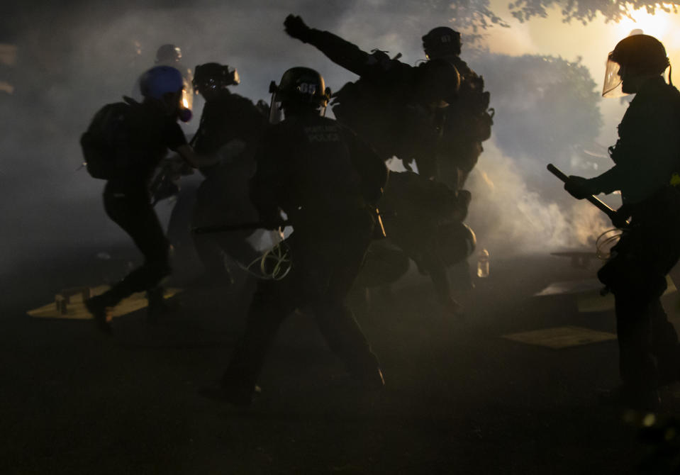 Police declared a riot around midnight as Portland protests continued for the 80th consecutive night Saturday, Aug. 15, 2020. Protesters gathered at Laurelhurst Park Saturday evening before marching to the Penumbra Kelly building. (Dave Killen/The Oregonian via AP)