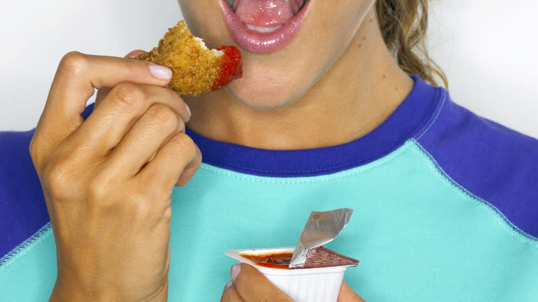 Woman eating chicken nugget