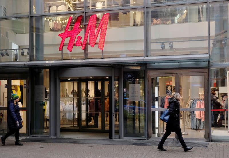 People walk past H&M shop in Riga