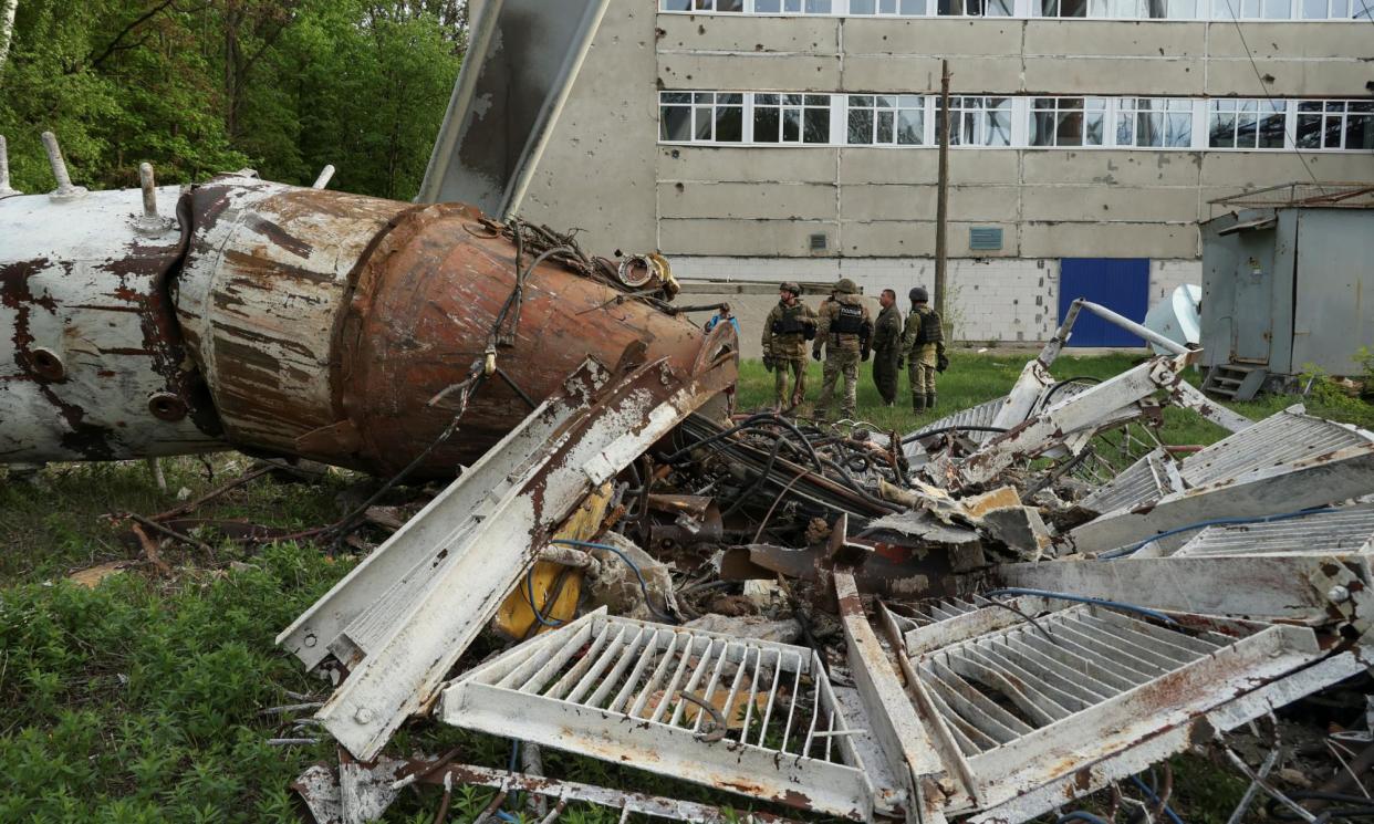 <span>Police officers stand next to a part of a television tower partially destroyed by a Russian missile strike on Kharkiv, Ukraine, 22 April 2024. The UK has promised vital equipment and funding to Kyiv to defend itself. </span><span>Photograph: Sofiia Gatilova/Reuters</span>