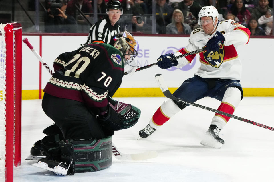 FILE - Arizona Coyotes goaltender Karel Vejmelka (70) makes a save on a shot by Florida Panthers right wing Patric Hornqvist, right, during the second period of an NHL hockey game in Tempe, Ariz., Nov. 1, 2022. Hornqvist will not play in the Stanley Cup Final for the Florida Panthers because of a December concussion, but the team insists he is still a big part of their success. (AP Photo/Ross D. Franklin, File)