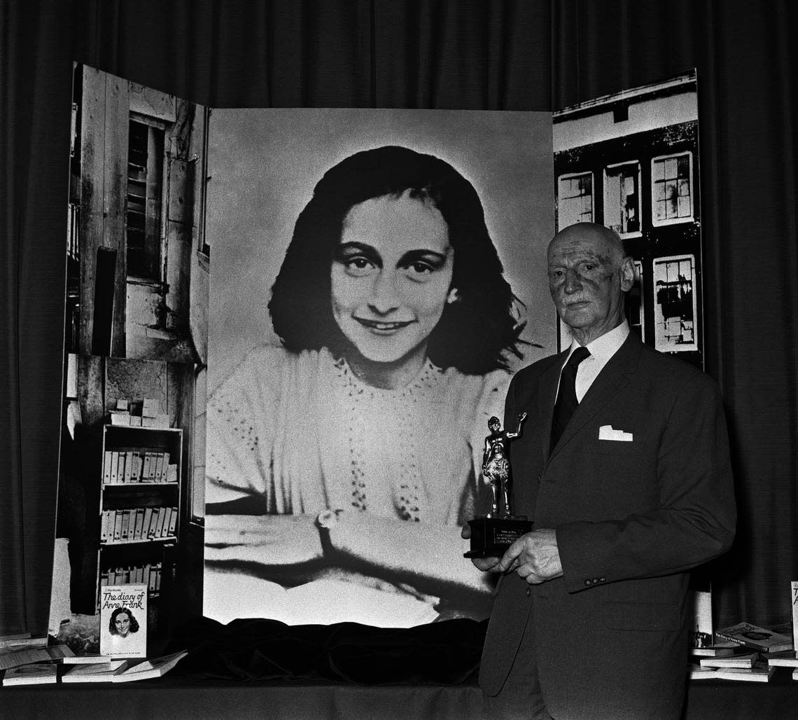 Otto Frank, Anne’s father and the family’s only survivor, stands in front of a photo of Anne Frank while accepting an award for “The Diary of Anne Frank” in London in 1971.
