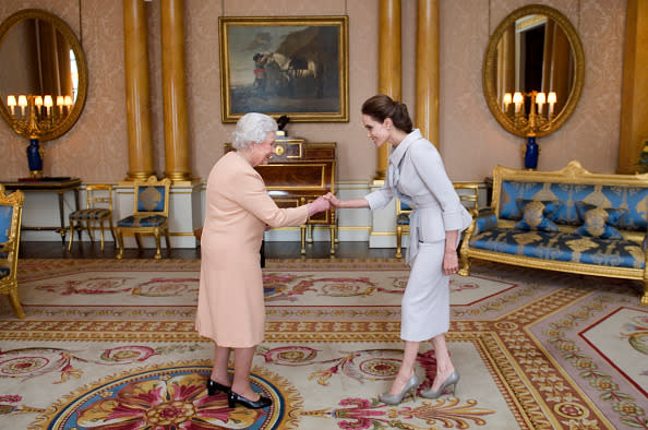 <p>Angelina proves to be the pin up for what to wear when one meets the queen. She looks chic and smart in this grey ensemble. <i>[Photo: Anthony Devlin - WPA Pool/Getty Images]</i></p>