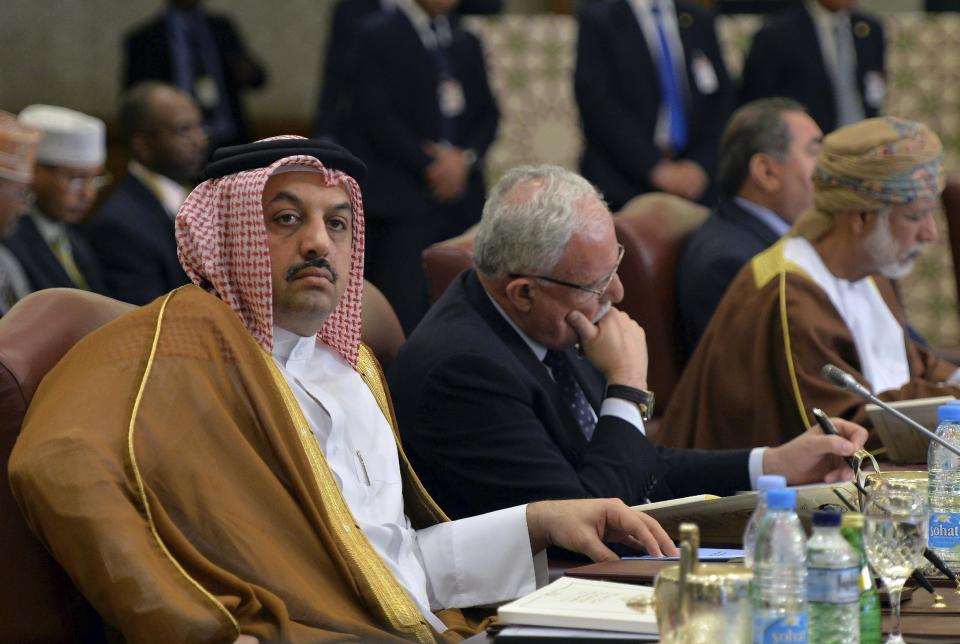 Qatar's Foreign Minister Sheik Khaled al-Attiyah, left, attends a session of Arab Foreign Ministers session in Kuwait City on Sunday, March 23, 2014. The Arab ministers held a preparatory meeting on Sunday prior to the 25th Arab Summit on Tuesday in Kuwait City. (AP Photo/Nasser Waggi)