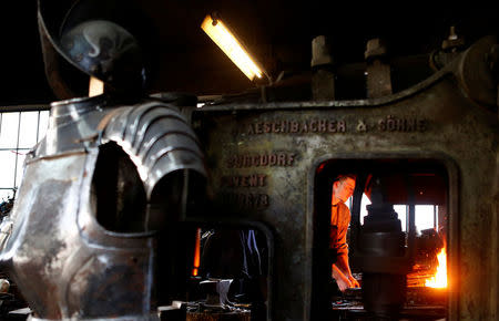 Blacksmith Johann Schmidberger works on an suit of armour for the Vatican's Swiss Guard at his workshop in Molln, Austria, March 29, 2017. Picture taken March 29, 2017. REUTERS/Leonhard Foeger