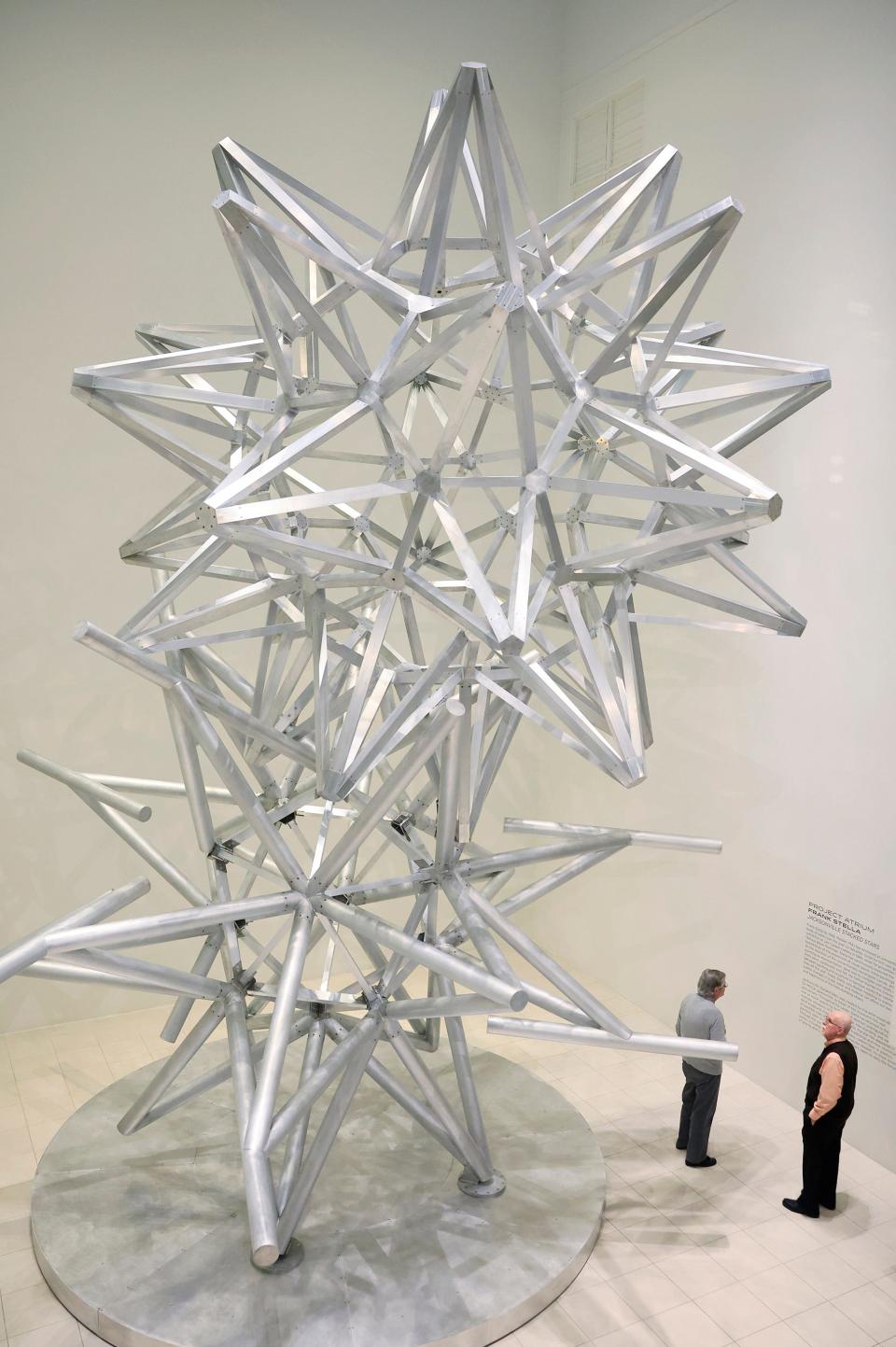 Bill Banks, left, and Eli Bekkum admire Jacksonville Stacked Stars, a new sculpture by artist Frank Stella unveiled Thursday, Feb. 29, 2024, as part of MOCA Jacksonville’s 100th anniversary.